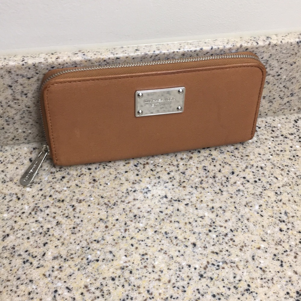 Michael Kors tan and silver wallet.